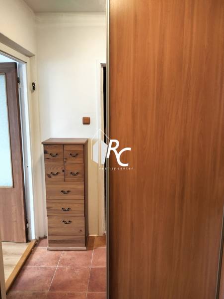 Entrance hallway of a 1-room apartment with storage space and tiles.