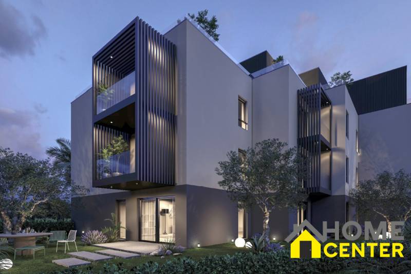 Exterior of a holiday apartment in the town of Hvar with a garden and terrace at sunset.