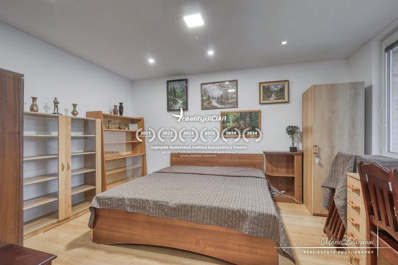 A bedroom in a 3-room apartment with wooden furniture and a floor with a wooden decor.