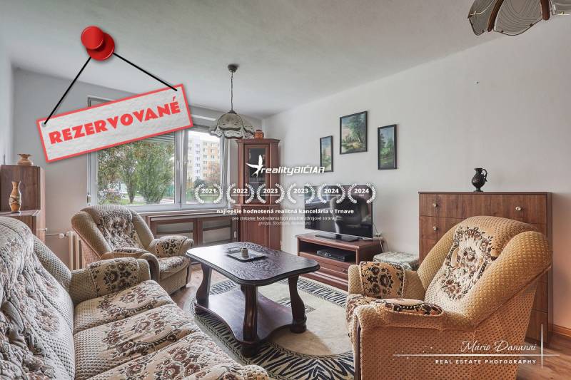 Living room with furniture in a 3-room apartment and a carpet. Reserved.