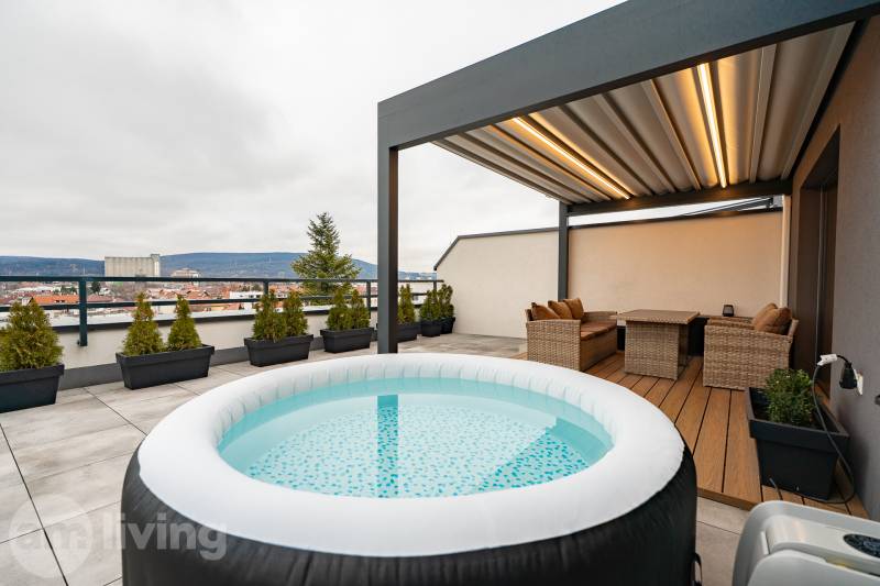 Rooftop terrace of a 3-room apartment on Kožušnícka Street in Trenčín with a hot tub and seating area.