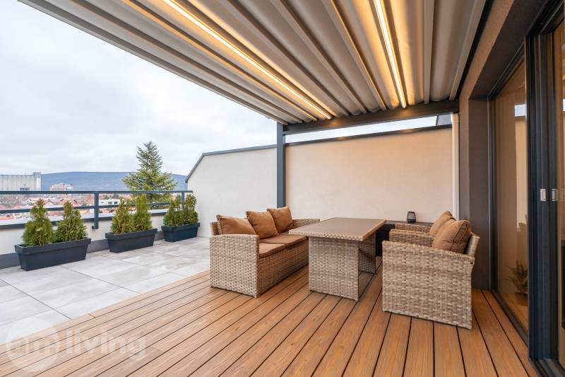 A terrace on Kožušnícka Street in Trenčín with elegant rattan furniture and a view.