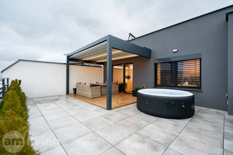 Terrace of a 3-room apartment with a hot tub and rattan furniture, Kožušnícka Street in Trenčín.