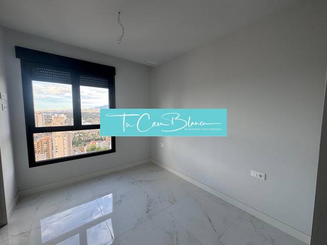 An empty room with a bright floor and a view in a 3-room apartment with marble.