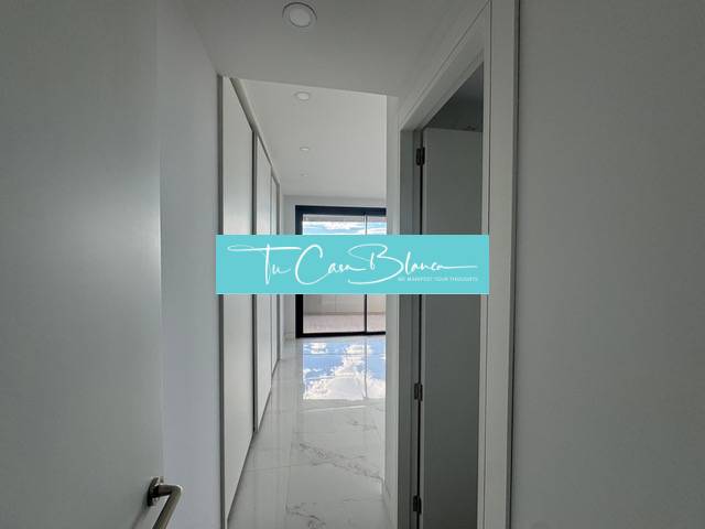 The hallway of a 3-room apartment with white walls and a glossy floor.