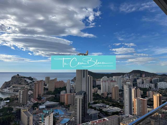 The city of Benidorm with a skyline of skyscrapers and the sea in the background.