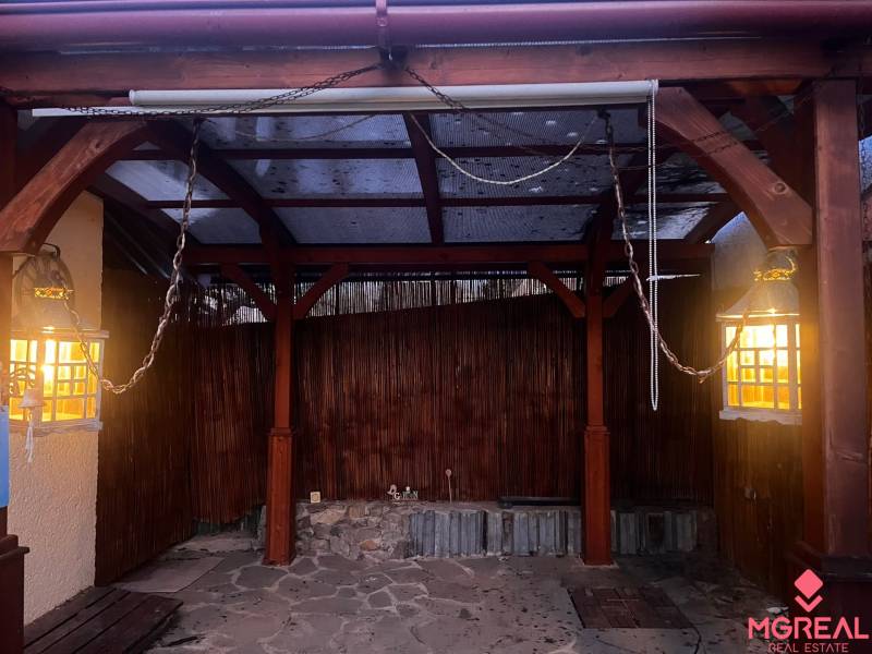 A wooden gazebo in a family house in Tvrdomestice with lights and a stone floor.