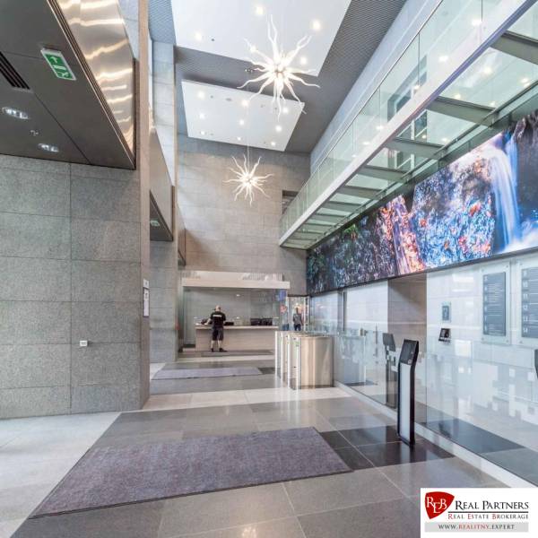 A modern entrance hall with a reception and lighting in offices.