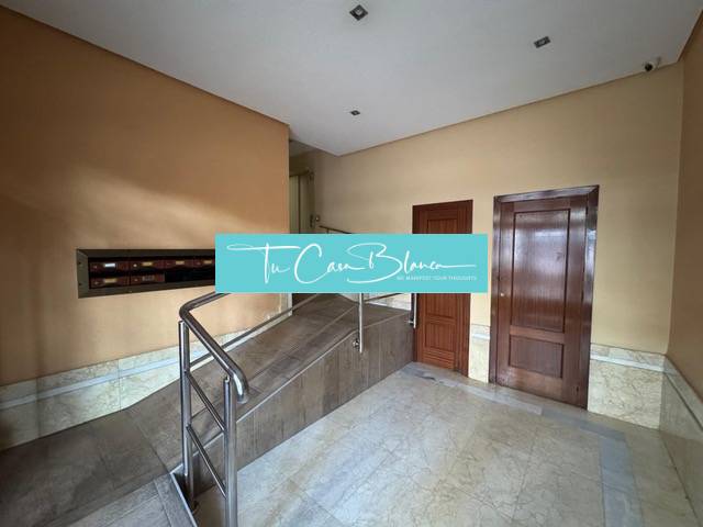 Interior with entrance hall and ramp in a 4-room apartment with marble cladding.