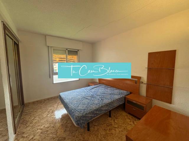 A bedroom in a 4-room apartment with a double bed, a mirrored wardrobe, and a wooden decor floor.