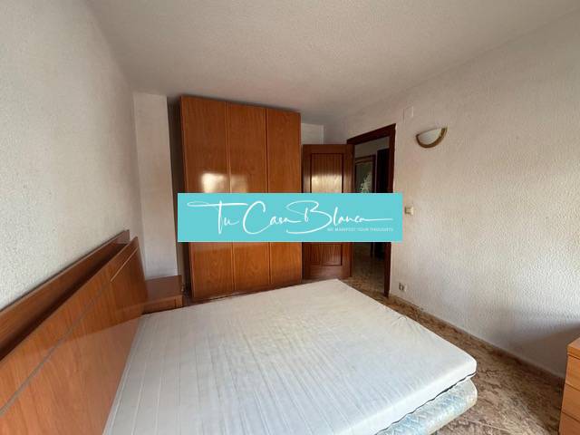 A bedroom with a built-in wardrobe and bed in a 4-room apartment.