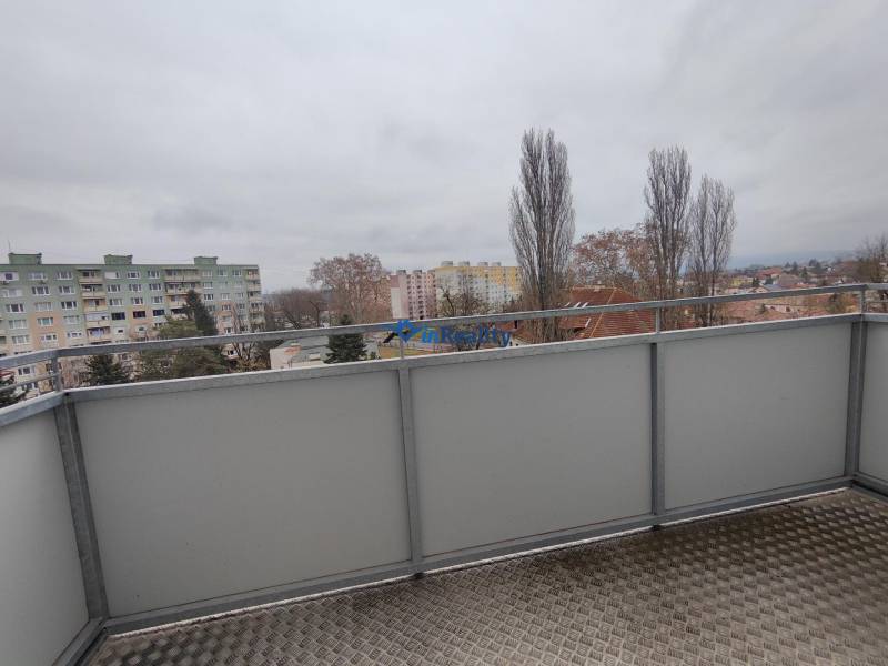 View from the balcony on V.V. Majakovského Street in Lučenec, with panel buildings in the background.