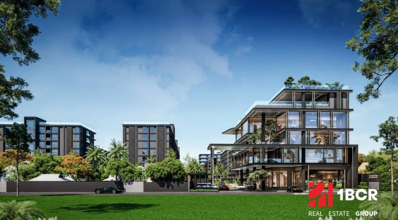 Apartment construction in Pattaya surrounded by greenery, modern buildings and cars in the background.