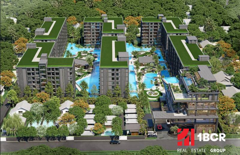 Apartment construction in Pattaya with pools and green roofs, surrounded by nature.