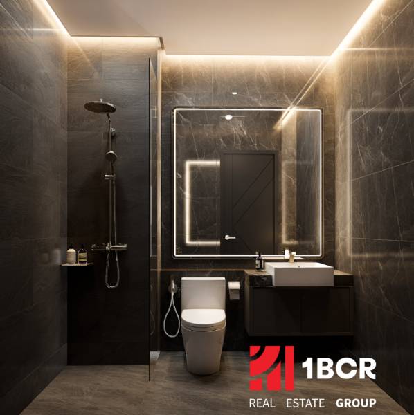 Elegant bathroom in a 2-room apartment with dark tiles and a mirror with lighting.