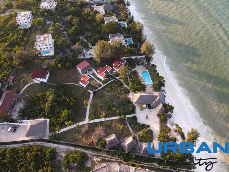 Aerial view of coastal bungalows and villas in Paje, Zanzibar South East, overlooking the ocean.