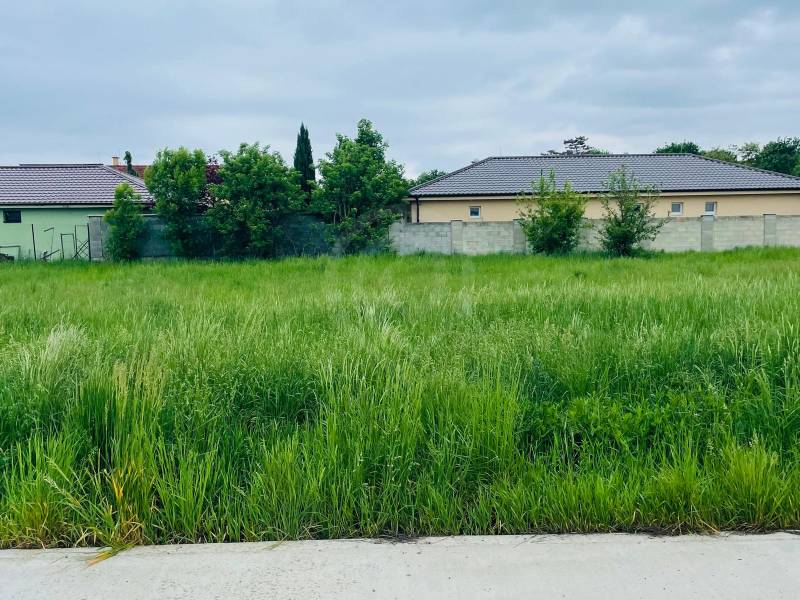 Land for housing on Podháj Street in Hviezdoslavov with buildings and greenery in the background.