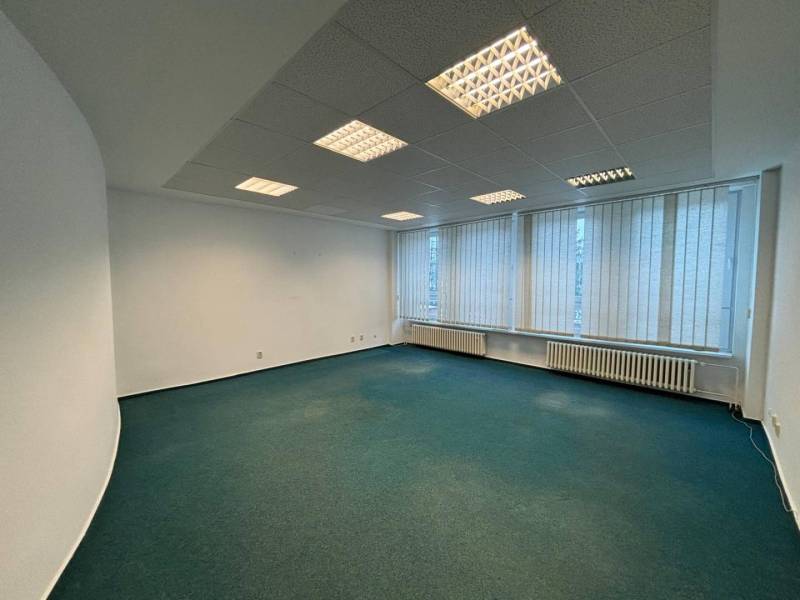 Offices with carpet, fluorescent lighting, and vertical blinds.