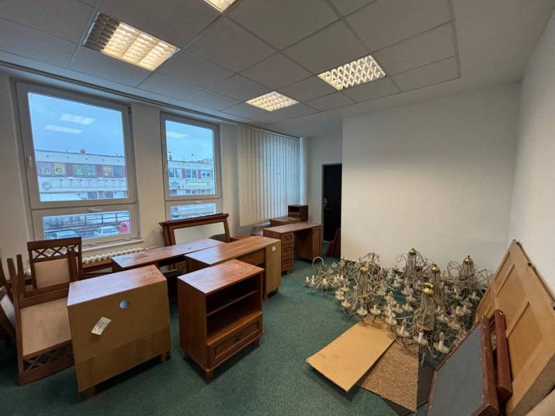 Offices with carpet flooring, furniture, and chandelier structures.