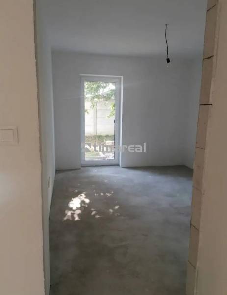 Interior of a family house with a view of an empty room and a garden.