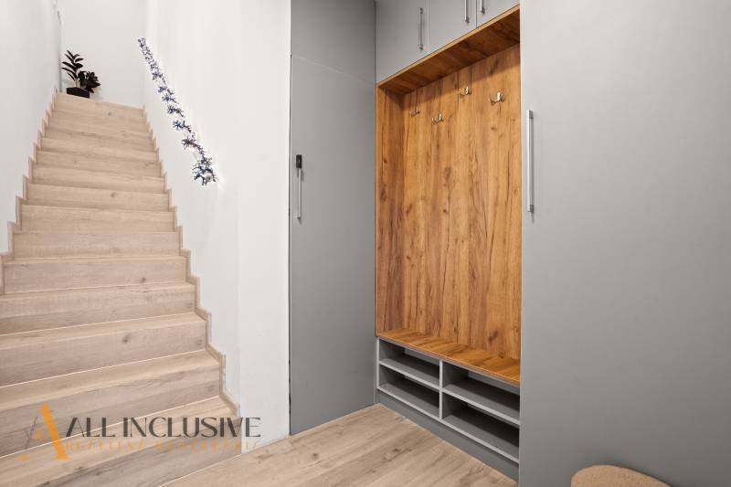 A staircase with a wooden decor floor and a built-in wardrobe in a 3-room apartment.