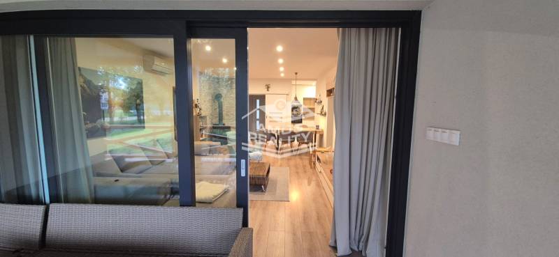 Interior of a family house with a wooden decor floor and comfortable seating.