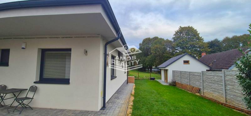 A family house in Studienka with a terrace, garden furniture, and a landscaped garden.