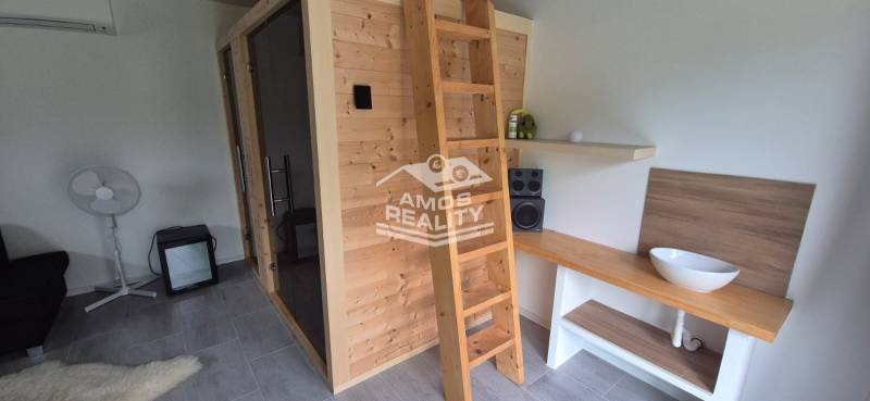 Interior of a family house with a wooden sauna, ladder, and stereo equipment.