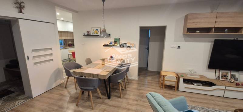 A dining room in a family house with wooden floor decor and a table for six people.