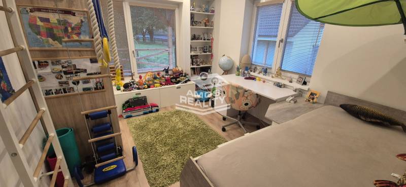 Children's room in a family house with toys, a table, and a floor with a wooden decor.