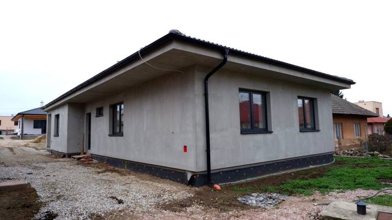 A family house in Radava with a simple facade and a sloped roof under construction.