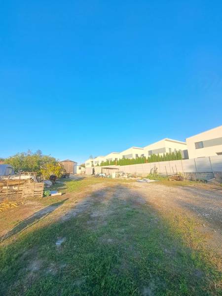 A view of family houses in Kolárovo with adjacent areas and a clear blue sky.