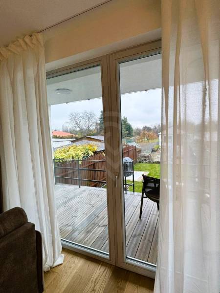 Interior of a family house with a view of the terrace and garden, floor with wooden decor.