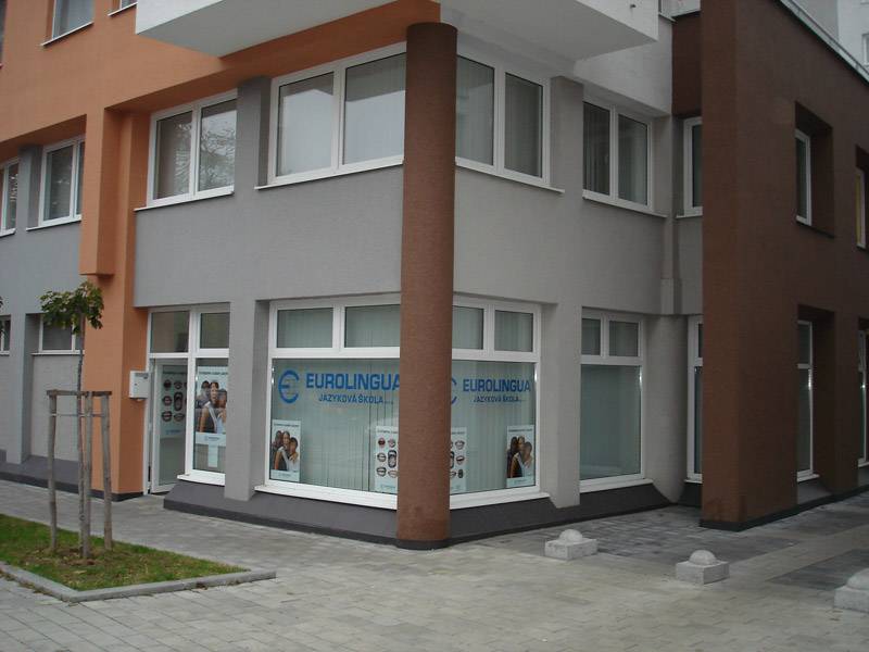 Commercial premises on Komárnická Street in Bratislava - Ružinov with large windows and an advertising sign.