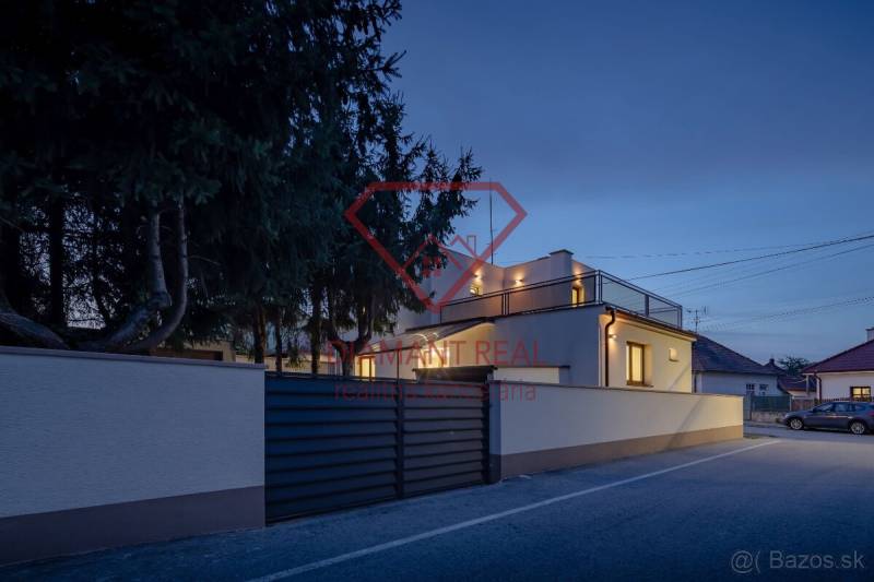 A family house on Trnovecká Street in Trnovec nad Váhom during evening lighting.