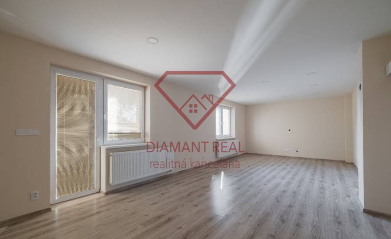 A bright room with a wood-decor floor in a family house, empty and ready.