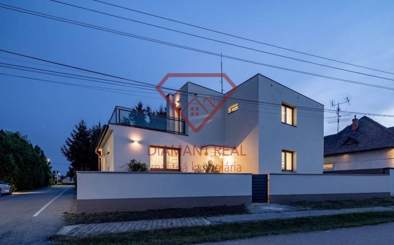 A family house on Trnovecká Street in Trnovec nad Váhom illuminated at dusk.