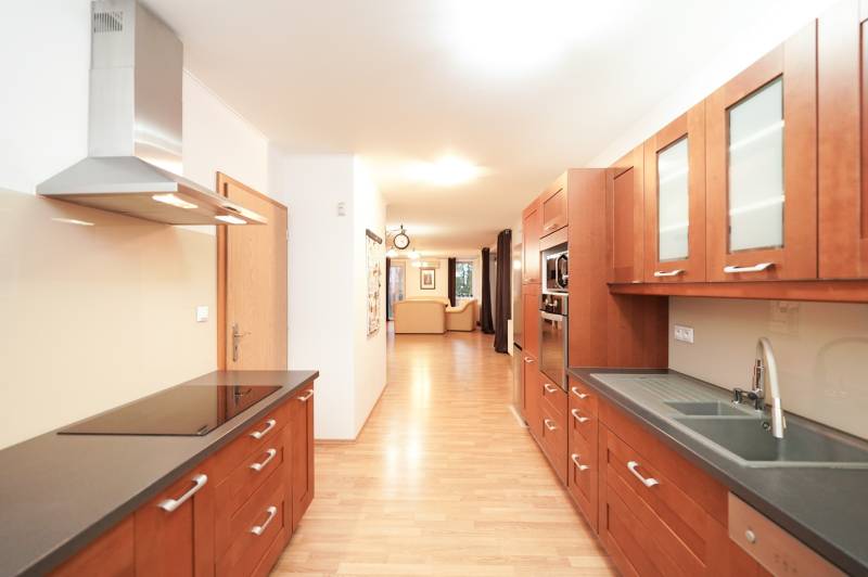 A kitchen in a family house with a wooden decor countertop and floor.