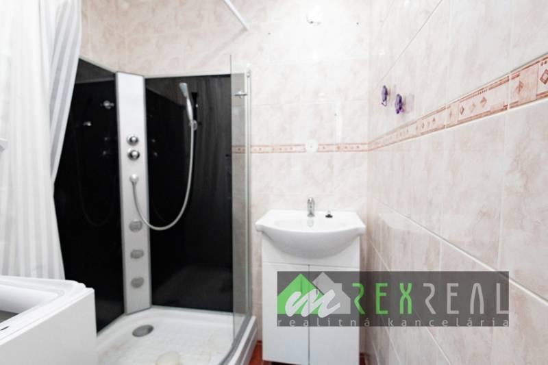 A bathroom in a 4-room apartment with a modern shower and a sink.