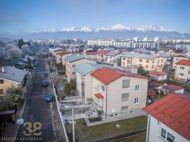 A view of terraced family houses in Poprad with the panorama of the Tatras in the background.