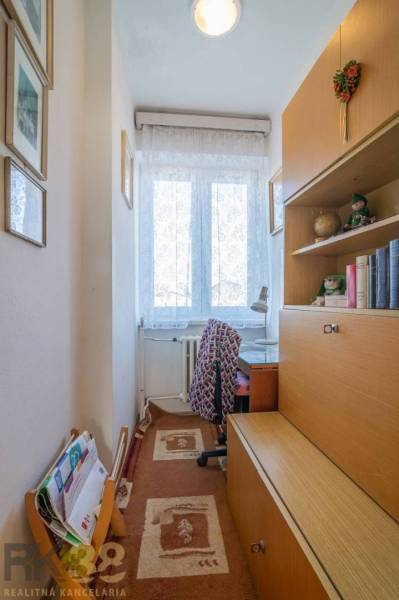 A cozy corner in a family house with a desk and a bookshelf.