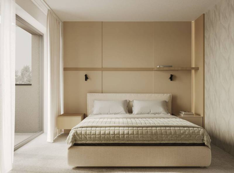 A bedroom with a bed, beige decor, and access to a balcony, decorated with a wall shelf.
