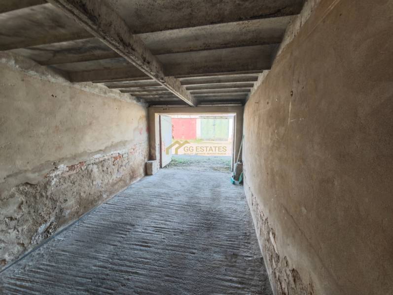 The interior of a garage with a concrete floor and raw walls on Okružná Street in Michalovce.