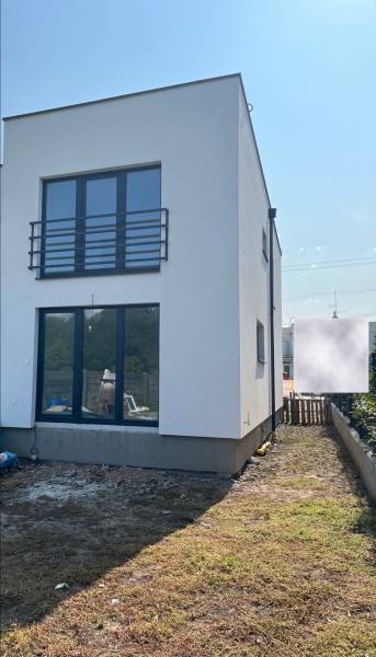 A family house on Zvončín Street in Zvončín with a grassy area in front of the building.