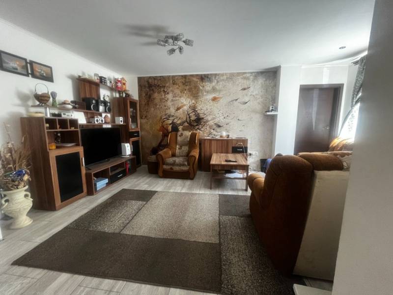 Living room in a family house with comfortable furniture and wooden floor decor.