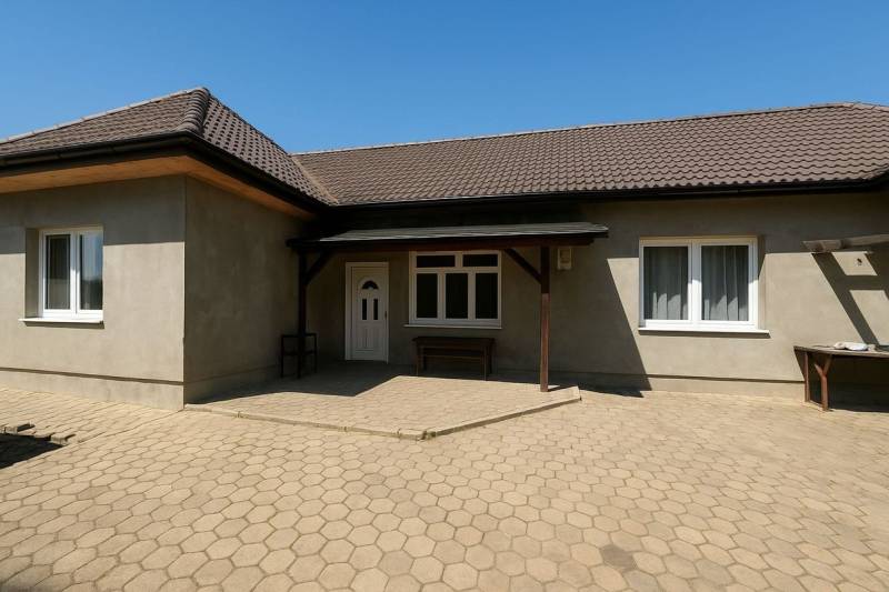 A family house in Tešedíkovo with a gabled roof and a paved courtyard.