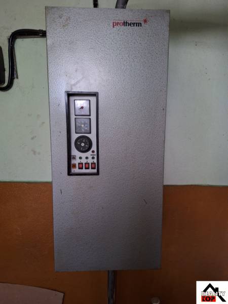 Protherm boiler on the interior wall of a family house with a control panel.