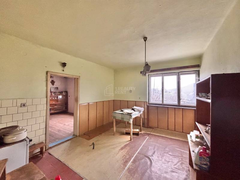 Interior of a family house with furniture, a window, and a floor with a wooden decor.
