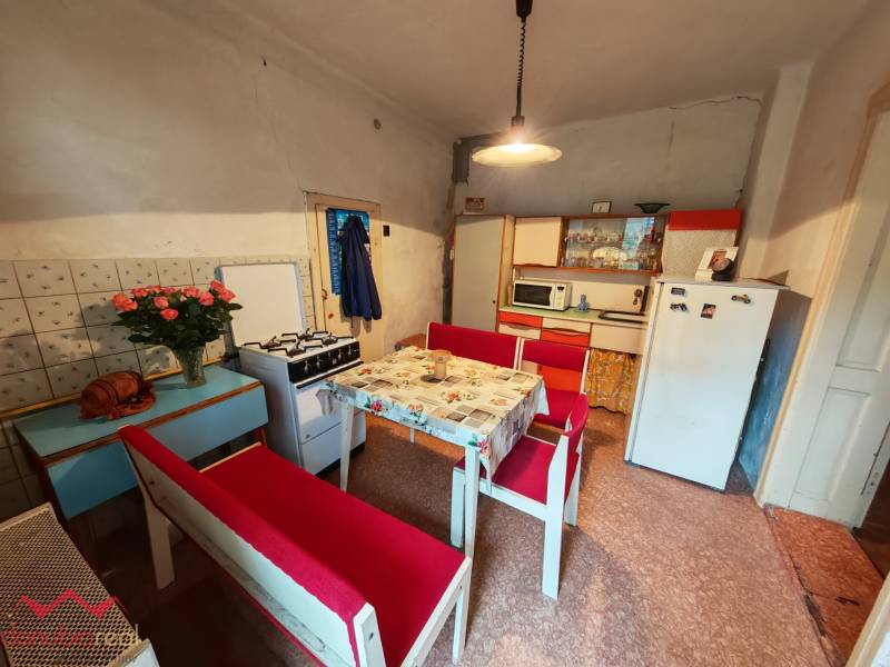 A kitchen in a family house with antique furniture and decorative elements.