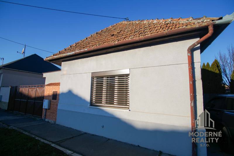 A family house on Pod kopcom Street in Nové Zámky with shutters and a sloped roof.